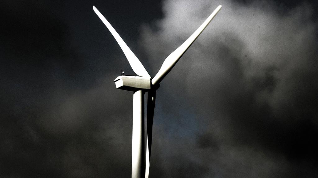 Futuristic solar field with turbines at sunset